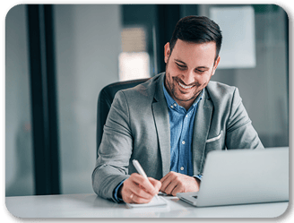 Aspiring trader studying at his laptop